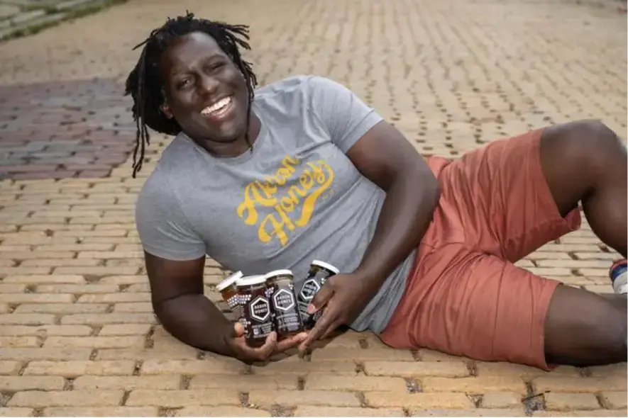 founder of akron hiney posing with his product